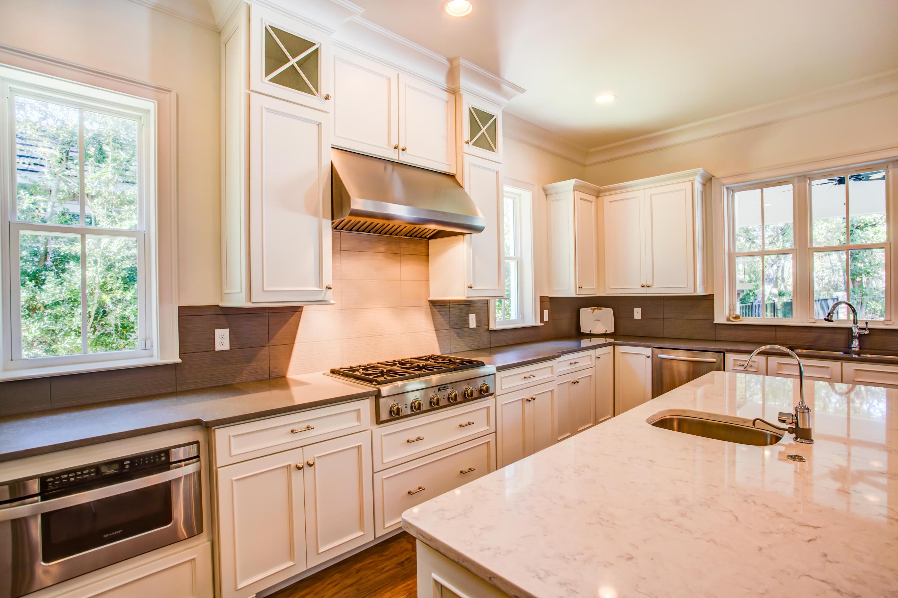 239 Mattie's Way Destin, FL 32541 - Photo 13 of 53 a kitchen with a stove a sink and a cabinets