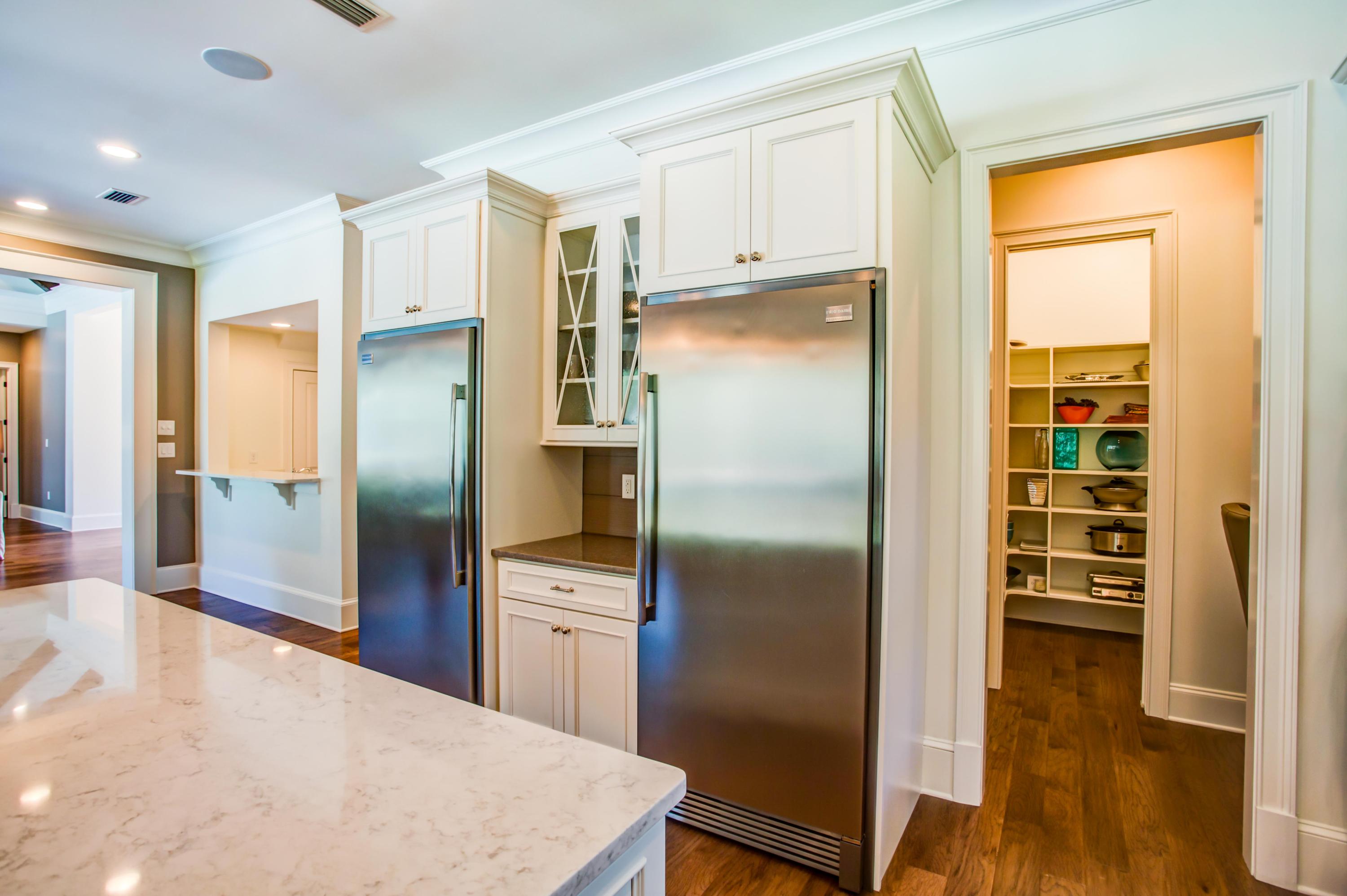 239 Mattie's Way Destin, FL 32541 - Photo 14 of 53 a kitchen with stainless steel appliances a refrigerator and wooden floor