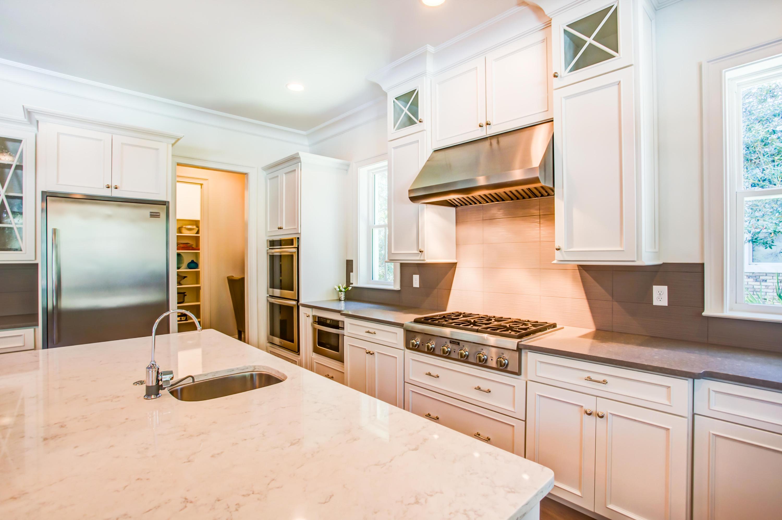 239 Mattie's Way Destin, FL 32541 - Photo 15 of 53 a kitchen with granite countertop a refrigerator and a stove top oven