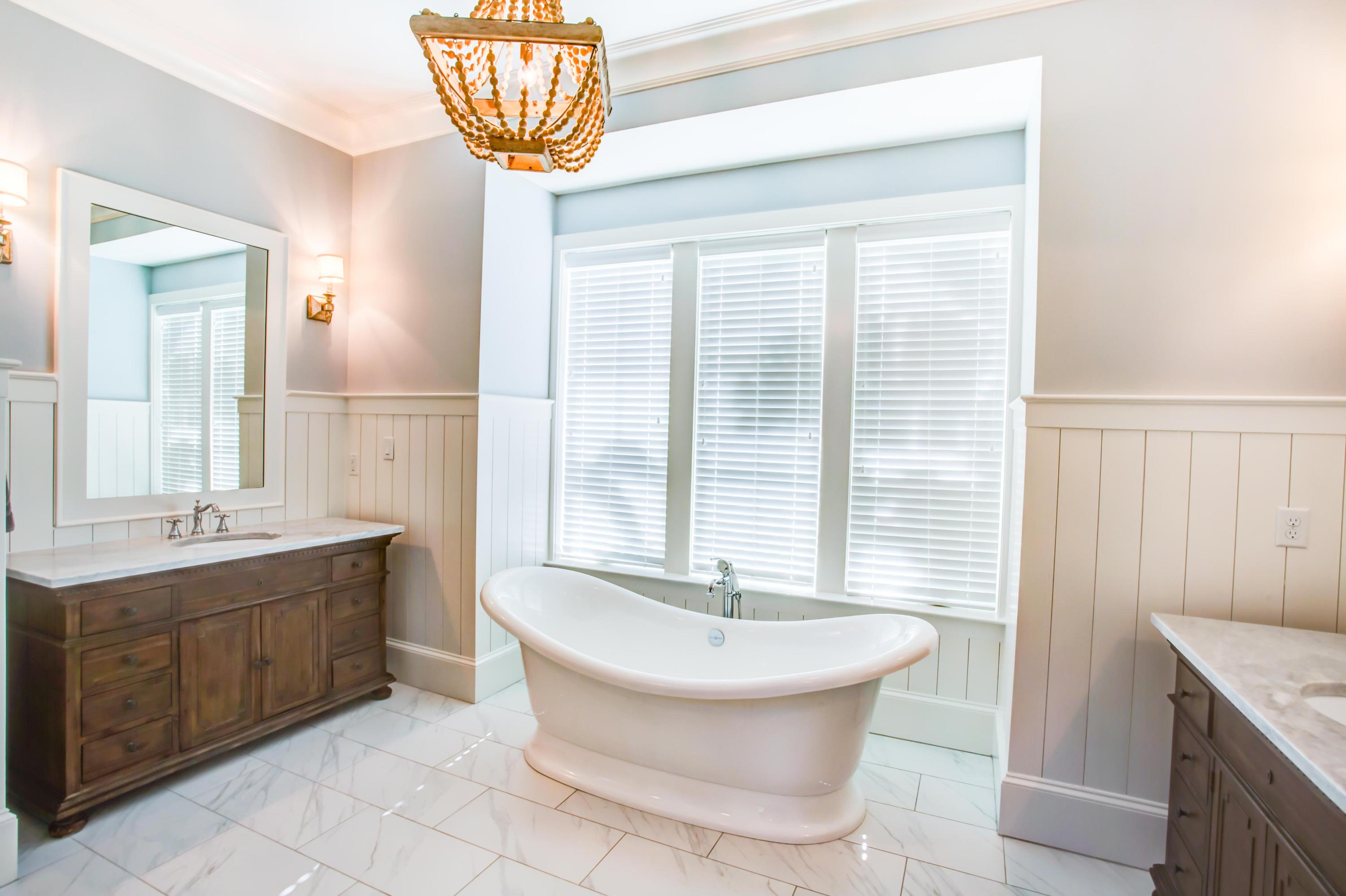 239 Mattie's Way Destin, FL 32541 - Photo 20 of 53 a bathroom with a sink a bathtub and a window