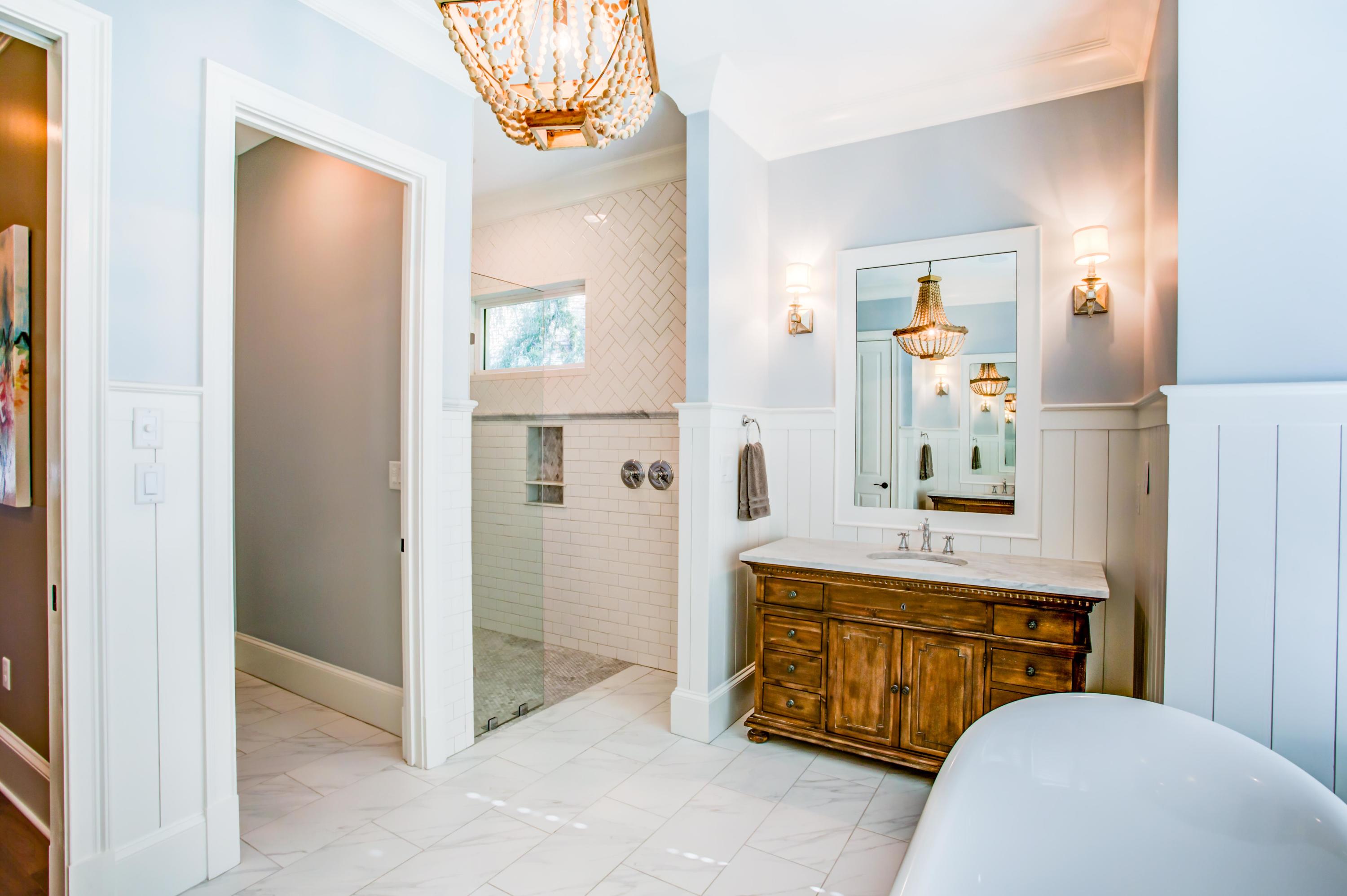 239 Mattie's Way Destin, FL 32541 - Photo 21 of 53 a bathroom with a sink a mirror and a shower