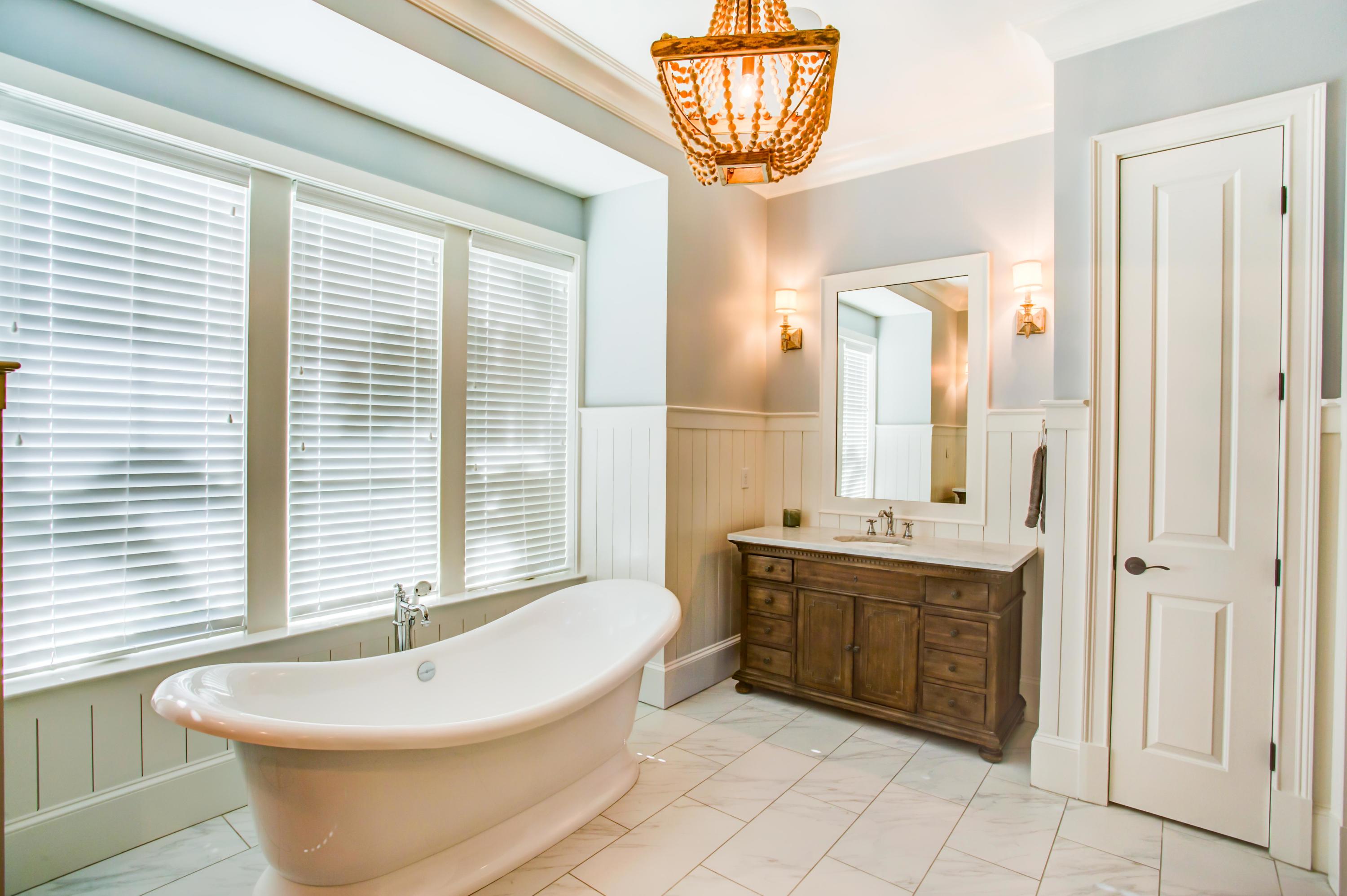 239 Mattie's Way Destin, FL 32541 - Photo 22 of 53 a spacious bathroom with a sink a bathtub a window and a mirror