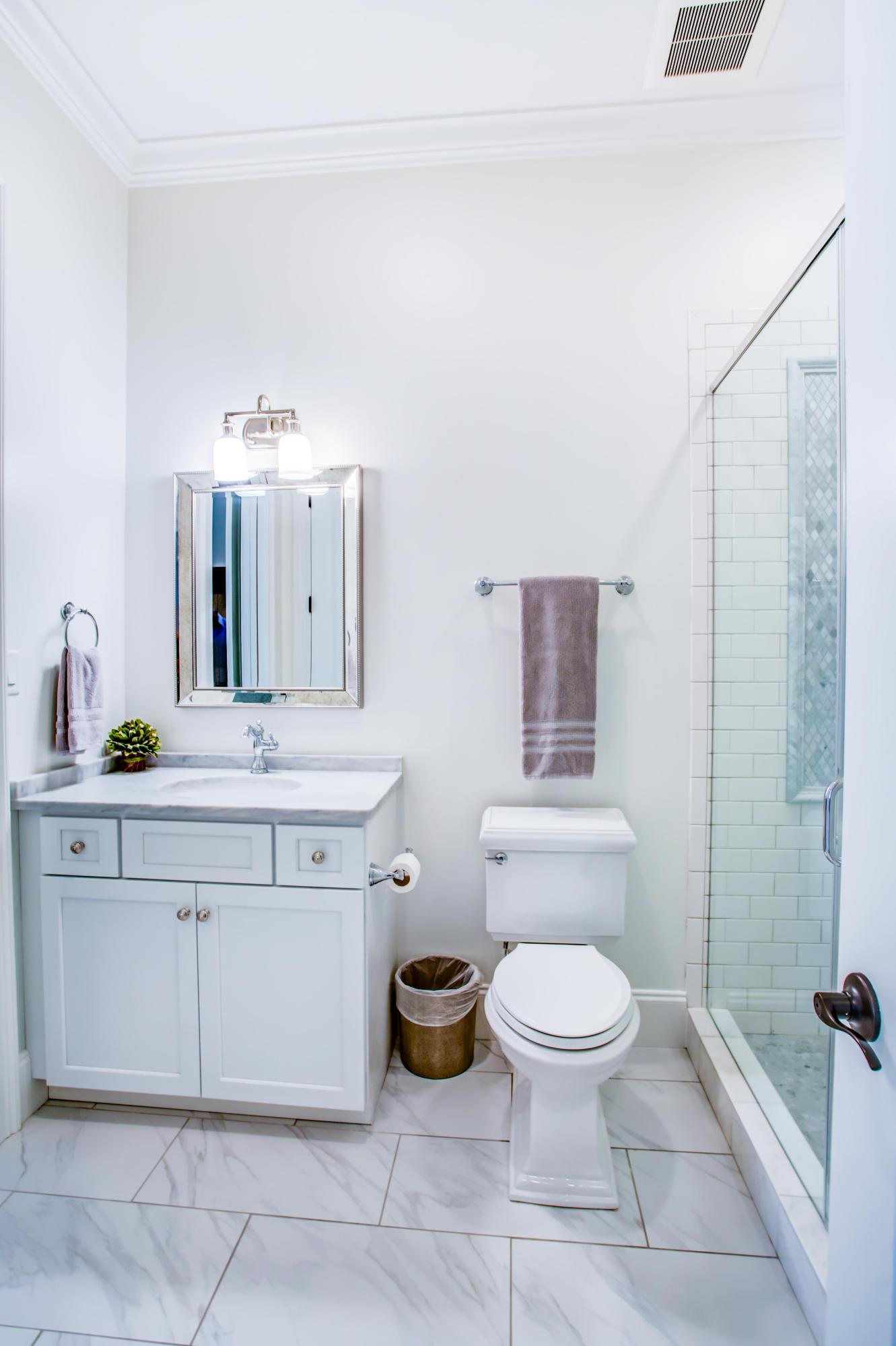 239 Mattie's Way Destin, FL 32541 - Photo 26 of 53 a spacious bathroom with a double vanity sink toilet and a mirror