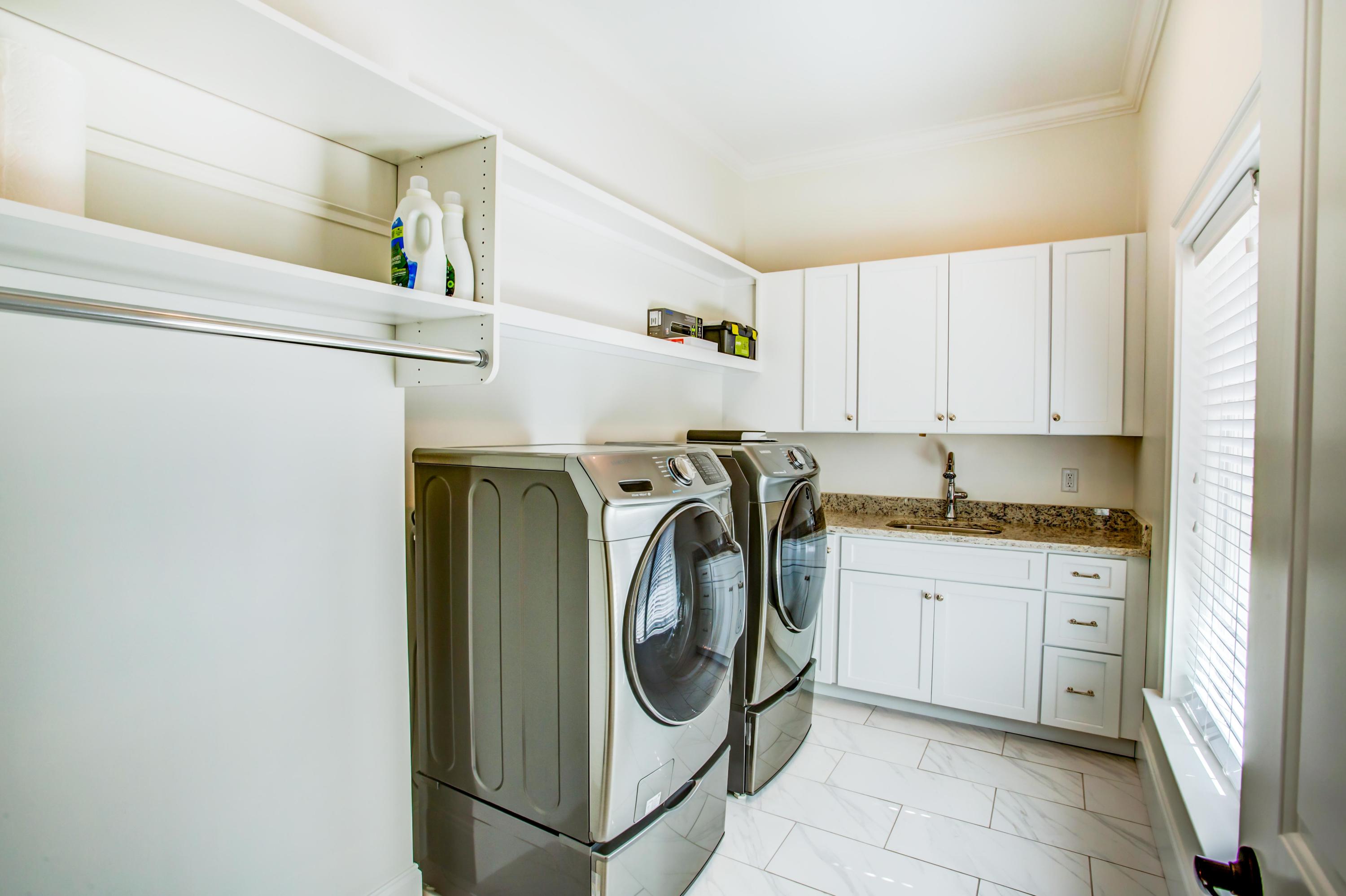 239 Mattie's Way Destin, FL 32541 - Photo 27 of 53 a utility room with dryer and washer