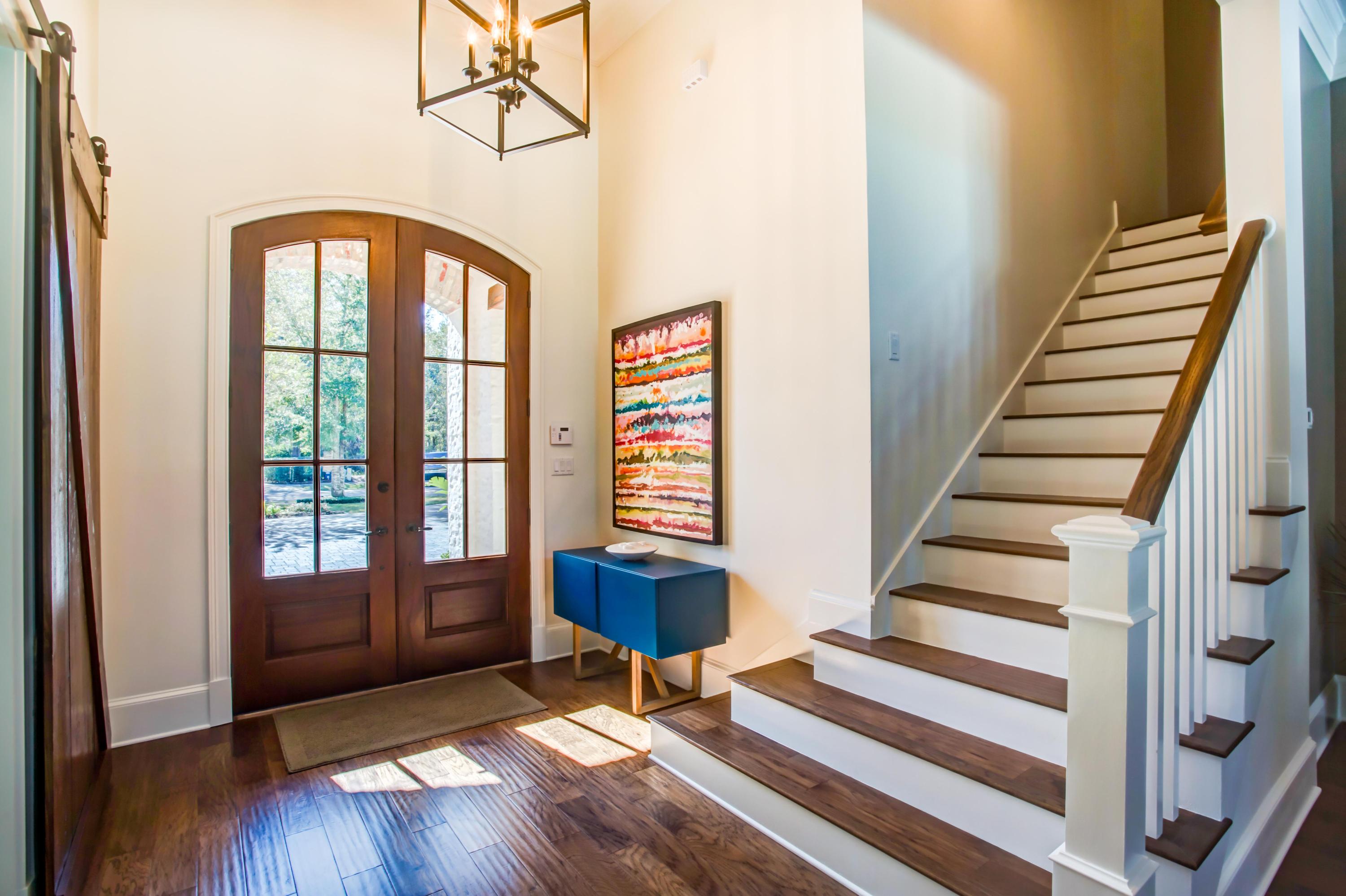 239 Mattie's Way Destin, FL 32541 - Photo 28 of 53 a view of front door with stairs and wooden floor