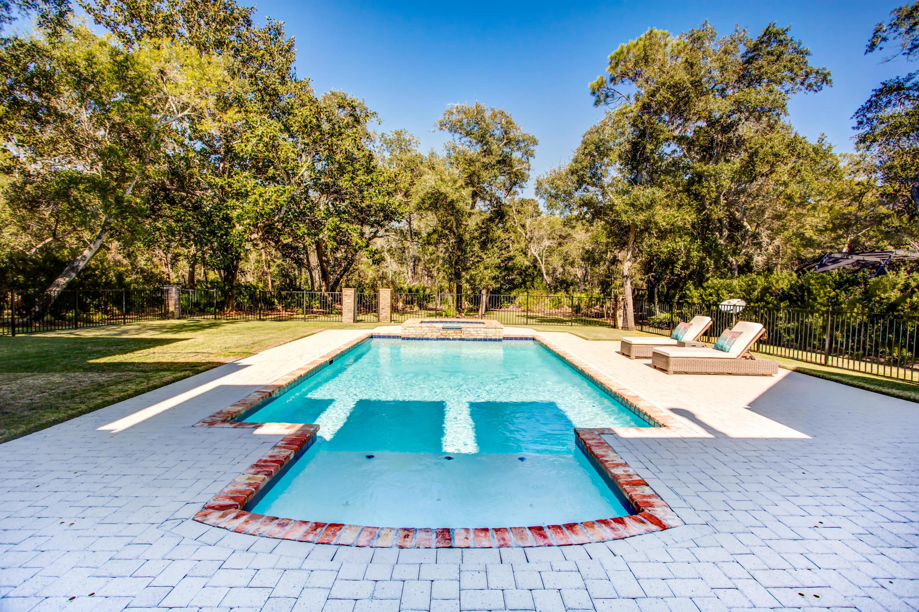 239 Mattie's Way Destin, FL 32541 - Photo 38 of 53 a view of a swimming pool with a lounge chairs