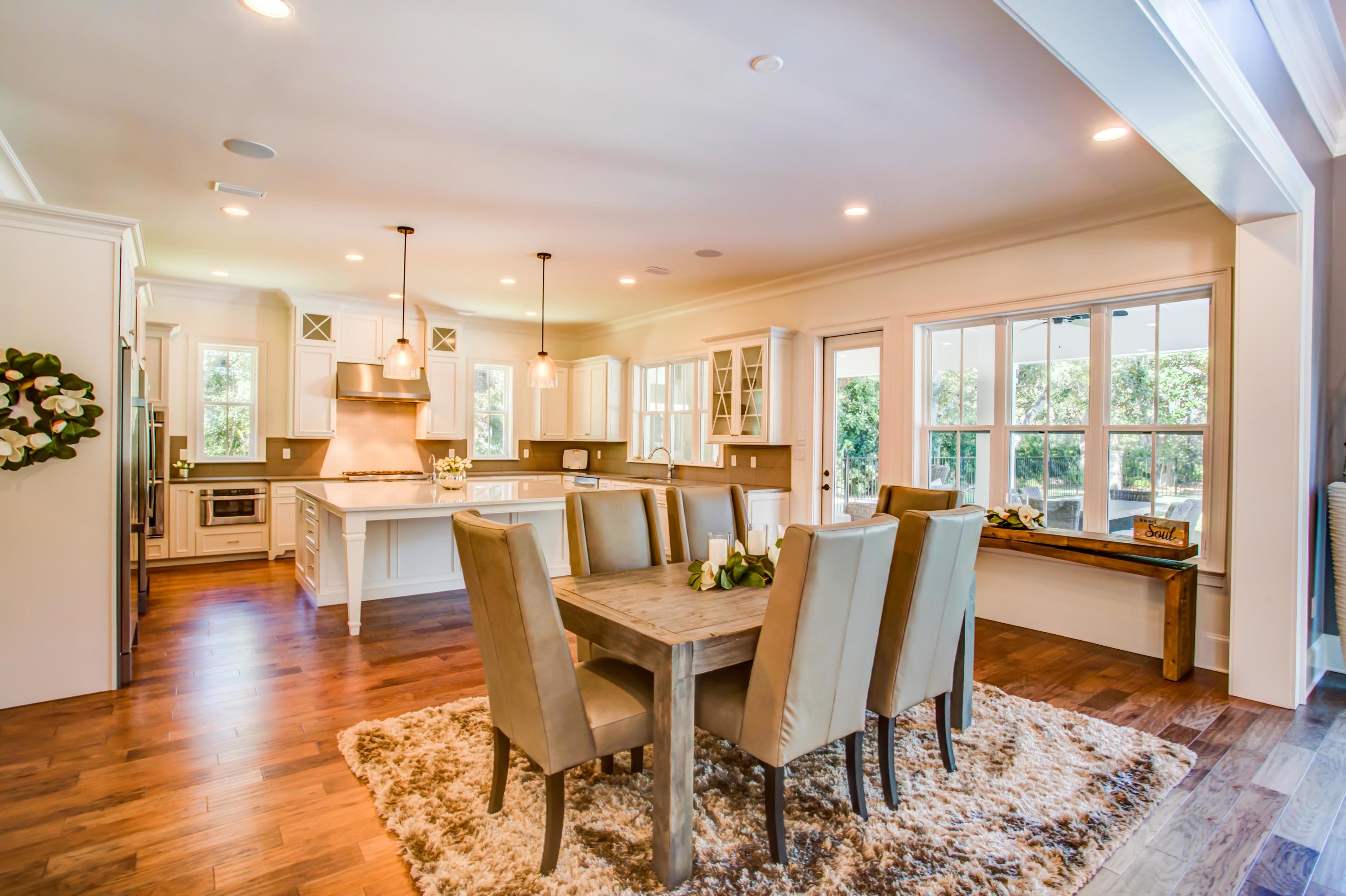 239 Mattie's Way Destin, FL 32541 - Photo 7 of 53 a view of a dining room with furniture and wooden floor