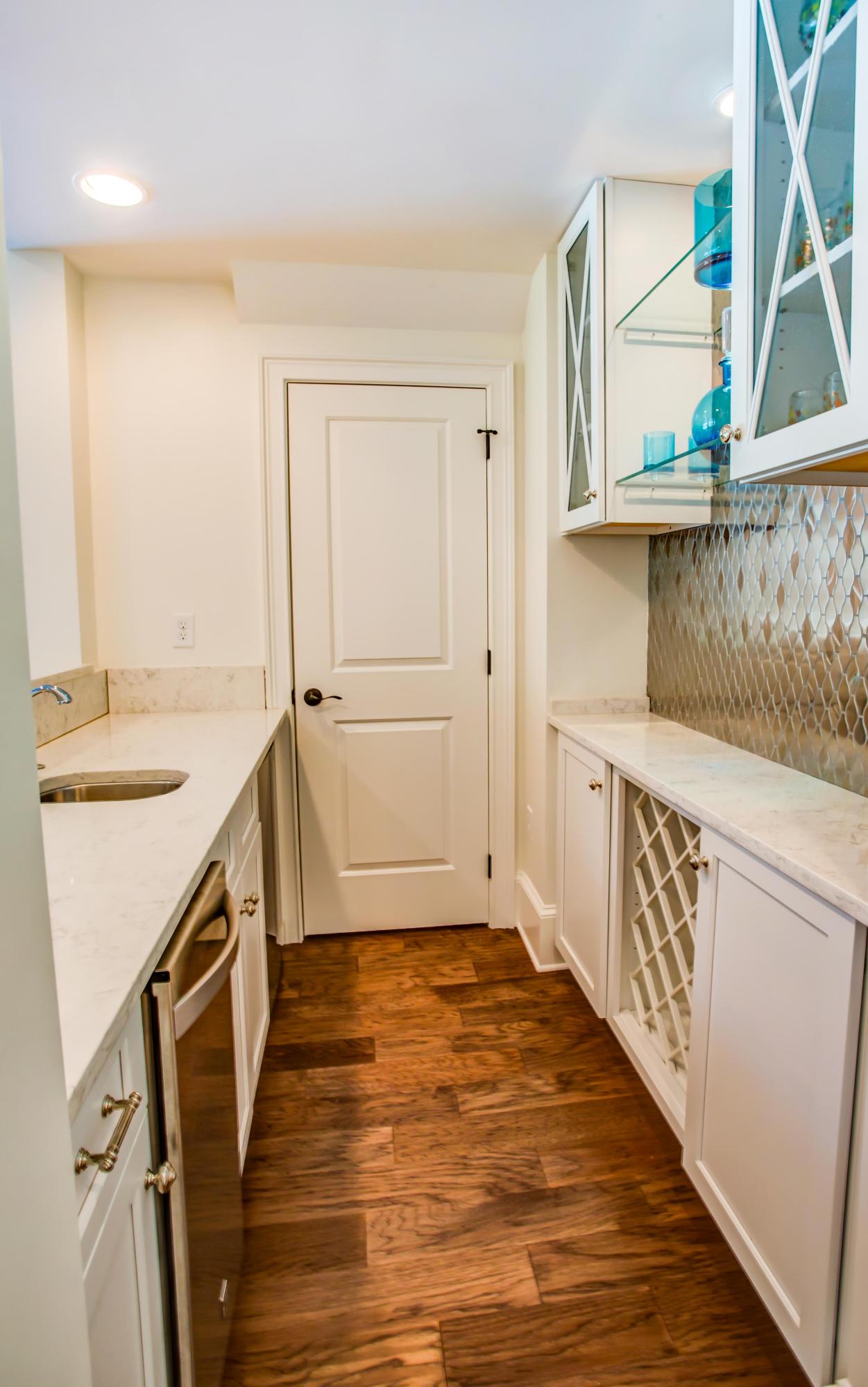 239 Mattie's Way Destin, FL 32541 - Photo 10 of 53 a kitchen with a sink stove and cabinets