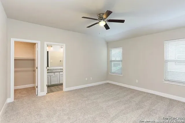 a view of a livingroom with a ceiling fan and window