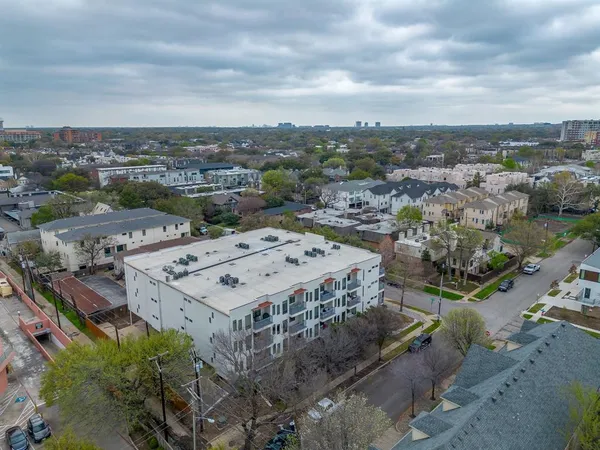 an aerial view of a houses with city view