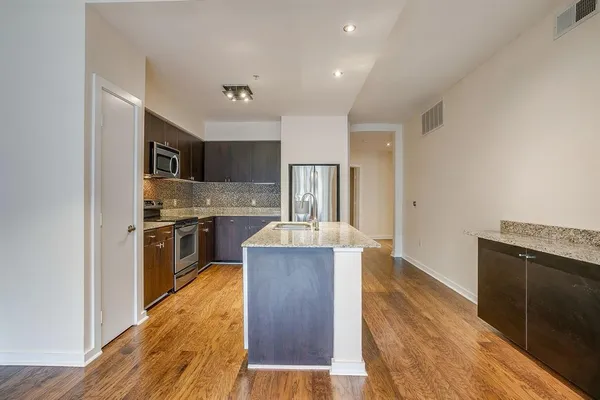 an empty room with closet and a ceiling fan