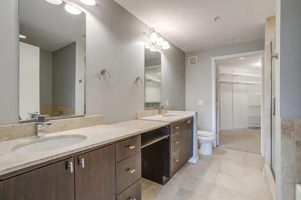a bathroom with a granite countertop sink mirror and double