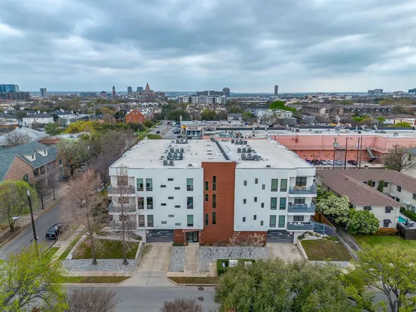an aerial view of a multi story parking building with outdoor space
