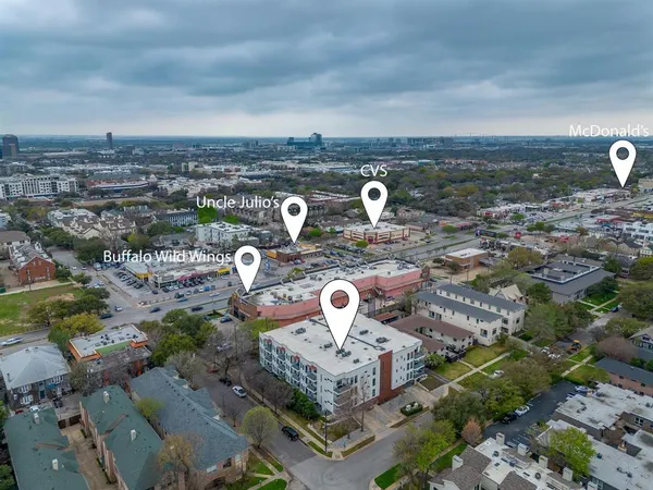 an aerial view of a house with yard