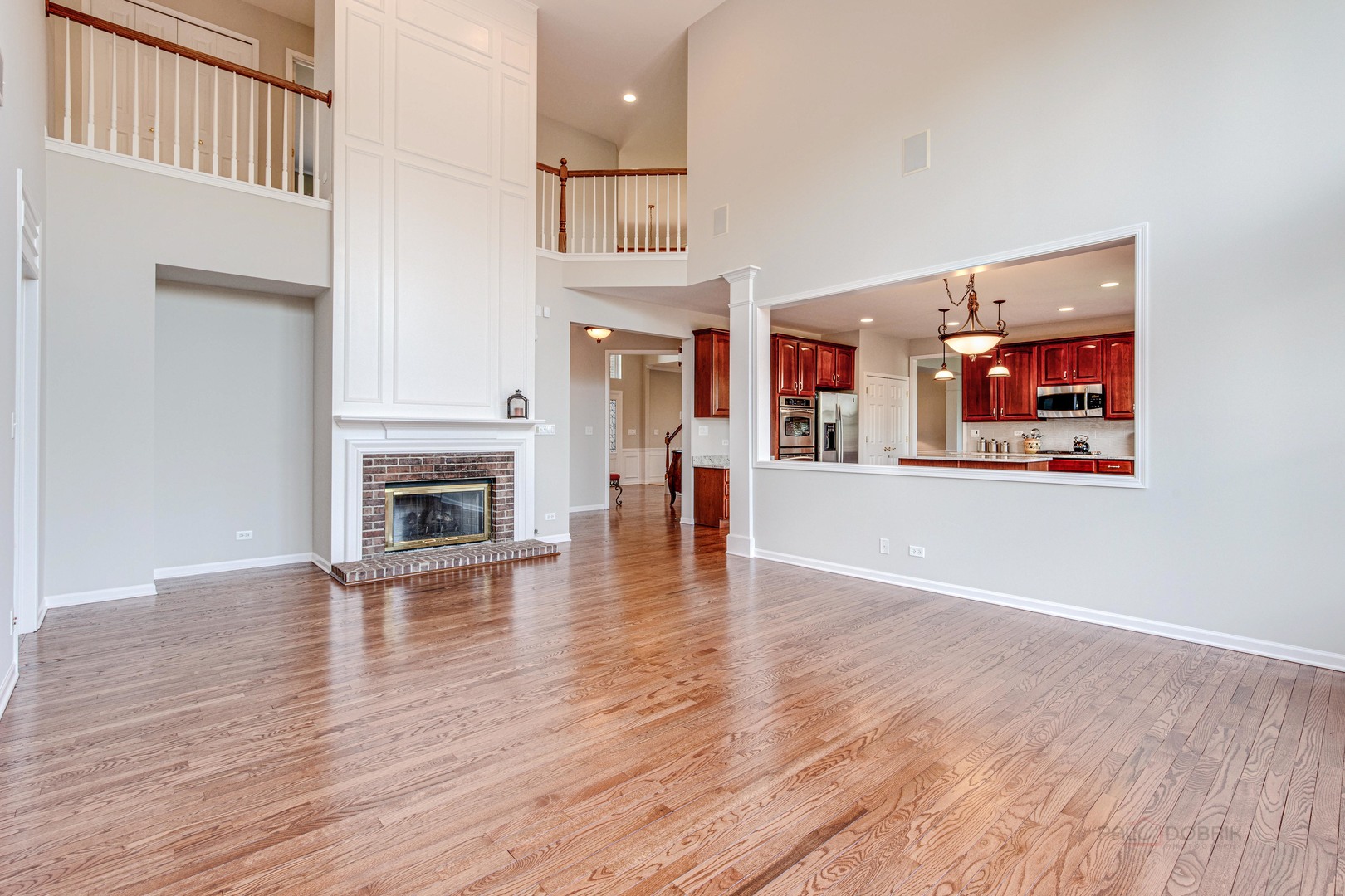 409 Wildflower Way Streamwood, IL 60107 - Photo 14 of 53 an empty room with wooden floor and a fireplace