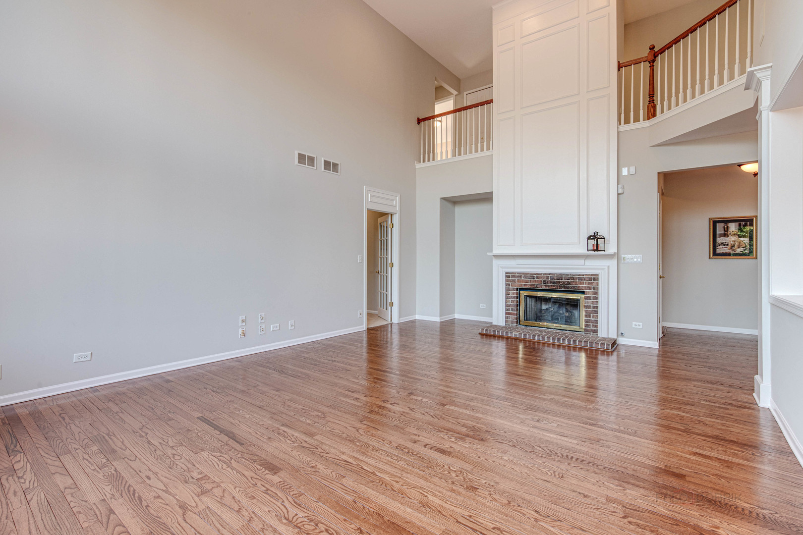 409 Wildflower Way Streamwood, IL 60107 - Photo 15 of 53 a view of empty room with wooden floor and fireplace