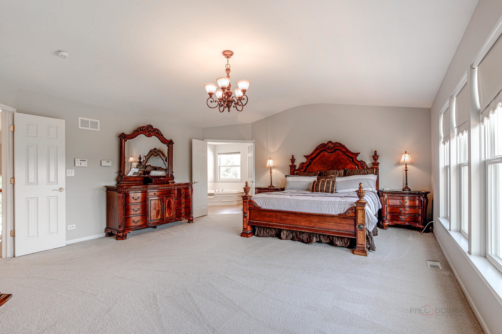 409 Wildflower Way Streamwood, IL 60107 - Photo 20 of 53 a bedroom with furniture and a chandelier