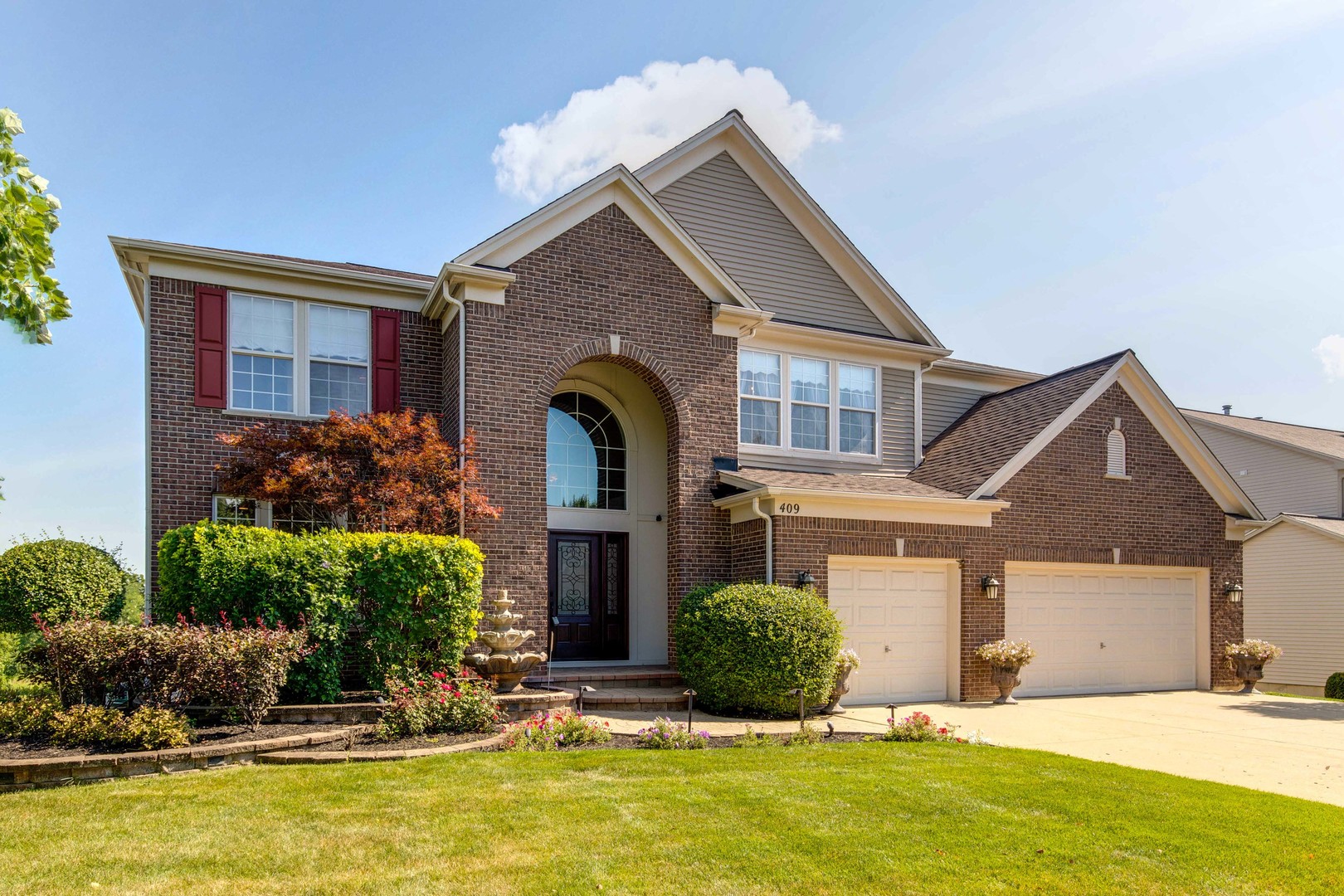 409 Wildflower Way Streamwood, IL 60107 - Photo 2 of 53 a front view of a house with a yard
