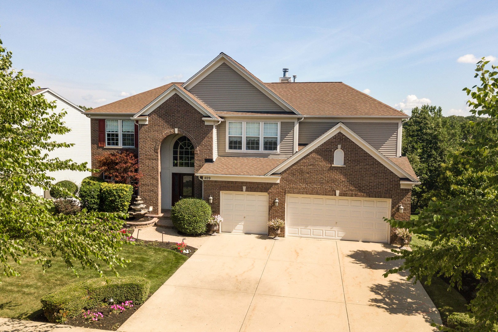 409 Wildflower Way Streamwood, IL 60107 - Photo 47 of 53 a front view of a house with garden