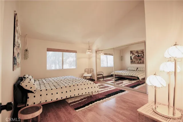 a bedroom with a bed and wooden floor