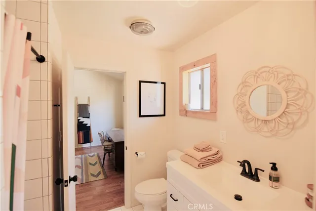 a bathroom with a sink mirror vanity and toilet