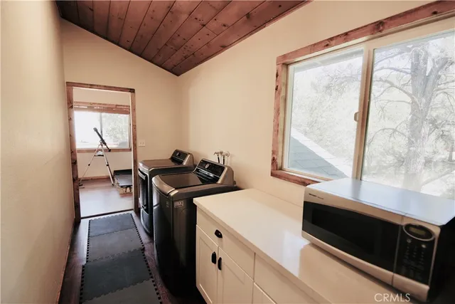 a view of a kitchen with a stove wooden floor and a window