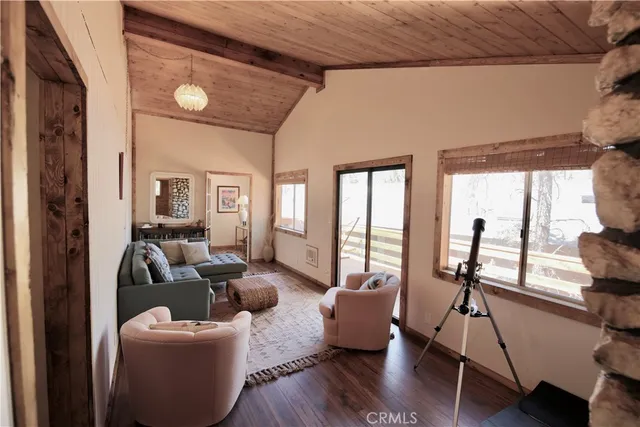 a living room with furniture or wooden floor and a large window