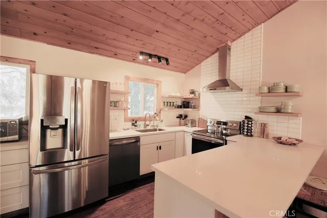a kitchen with appliances a sink and cabinets