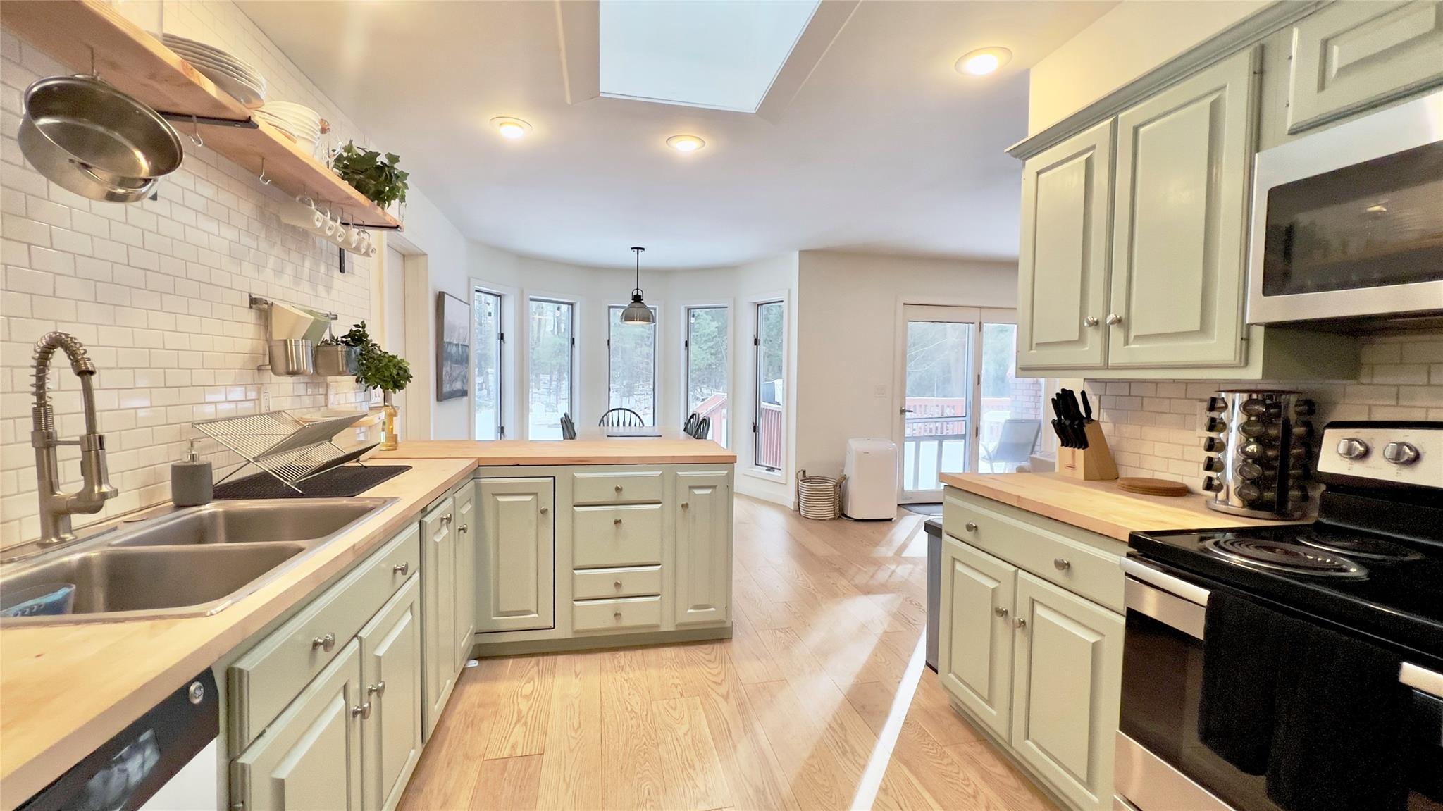 471 Horseshoe Lake Road Swan Lake, NY 12783 - Photo 15 of 39 a kitchen with a sink stove and cabinets