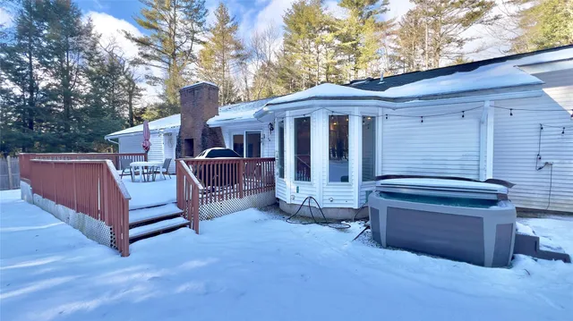 a view of a house with a yard and wooden fence