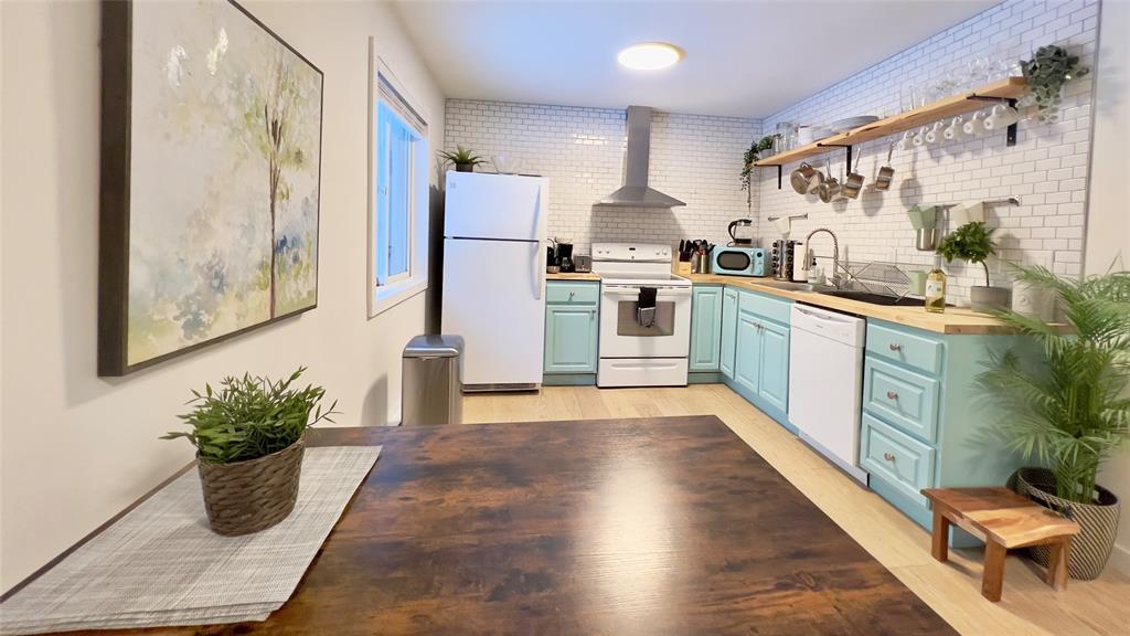 471 Horseshoe Lake Road Swan Lake, NY 12783 - Photo 35 of 39 a kitchen with stainless steel appliances kitchen island granite countertop a refrigerator a stove top oven and a potted plant