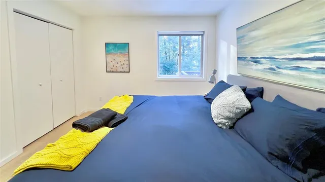 a bed sitting in a bedroom next to a window