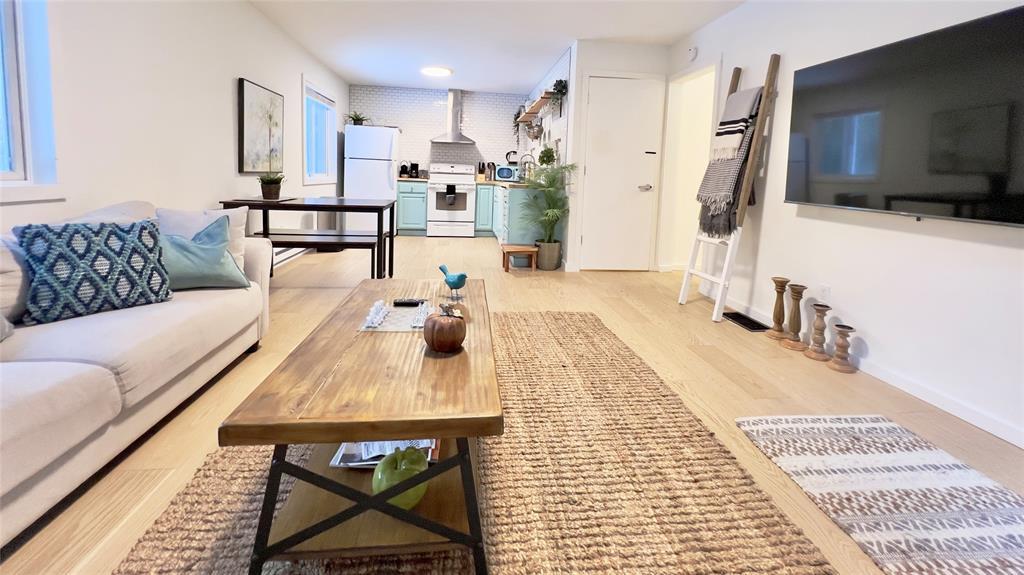 471 Horseshoe Lake Road Swan Lake, NY 12783 - Photo 39 of 39 a living room with stainless steel appliances furniture a rug and a flat screen tv