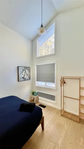 a bedroom with a bed and a window