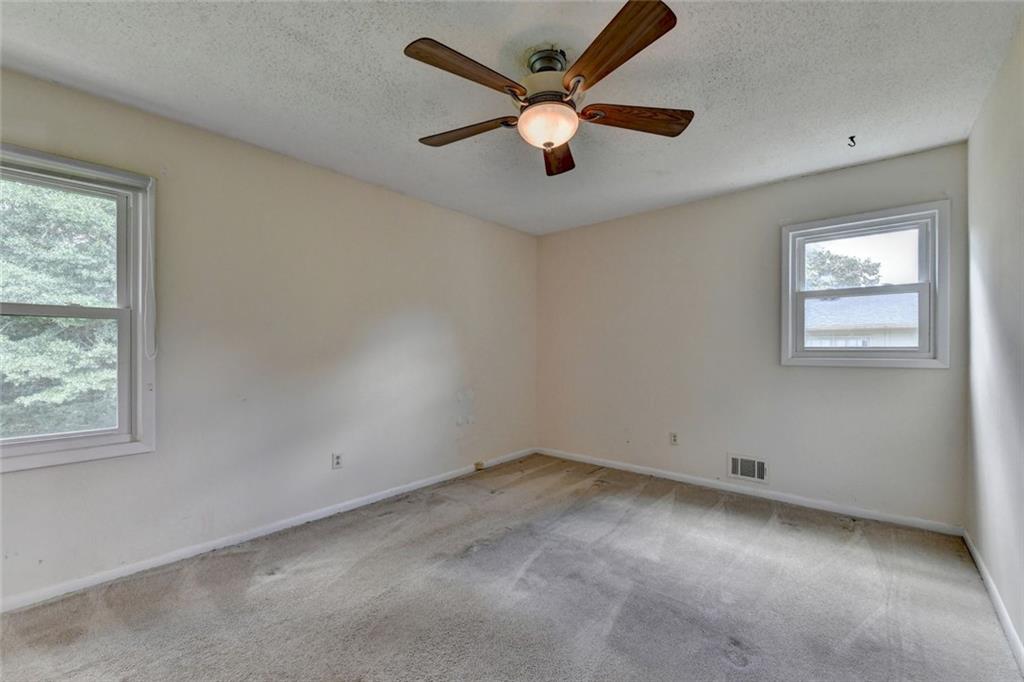 1577 Harbour Oaks Road Tucker, GA 30084 - Photo 27 of 58 an empty room with a window and a fan