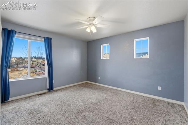 2224 Reed Grass Way Colorado Springs, CO 80915 - Photo 35 of 39 Spare room featuring carpet flooring and a ceiling fan