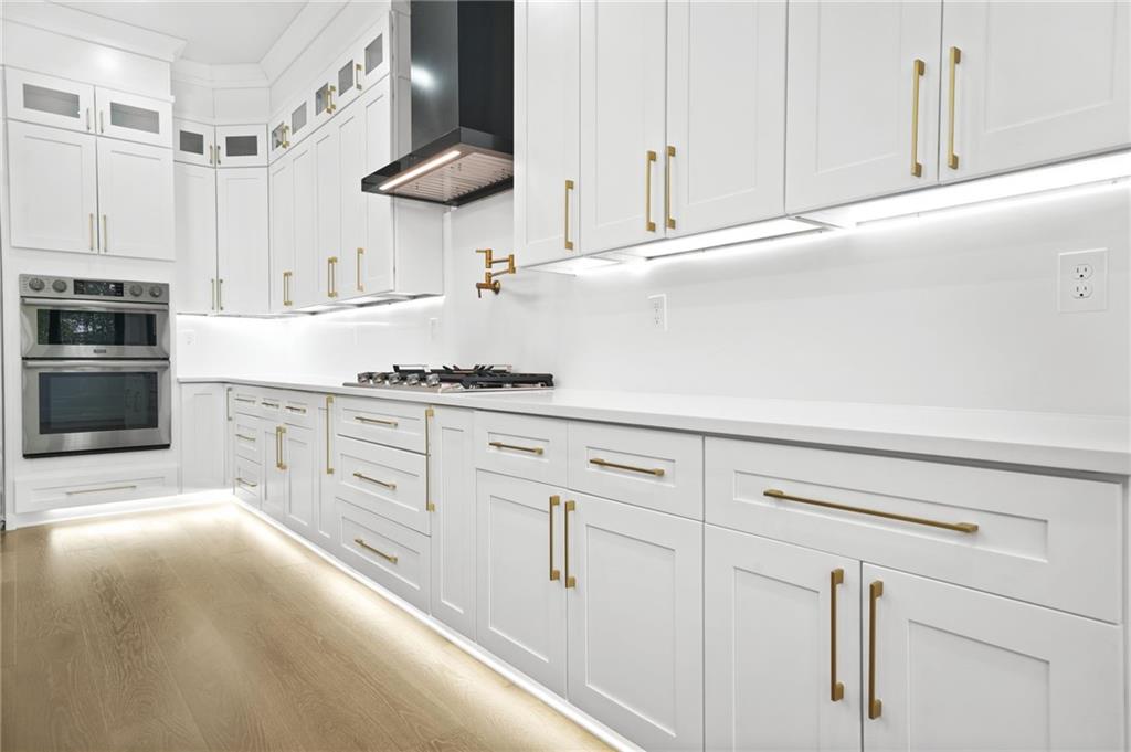 5175 Cascade Road Atlanta, GA 30331 - Photo 11 of 62 a kitchen with granite countertop white cabinets and stainless steel appliances