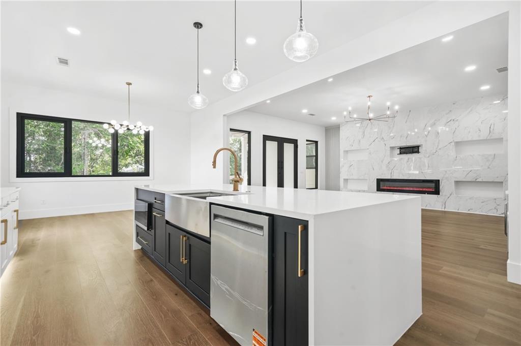 5175 Cascade Road Atlanta, GA 30331 - Photo 12 of 62 a large kitchen with kitchen island a stove a sink a center island and wooden floor