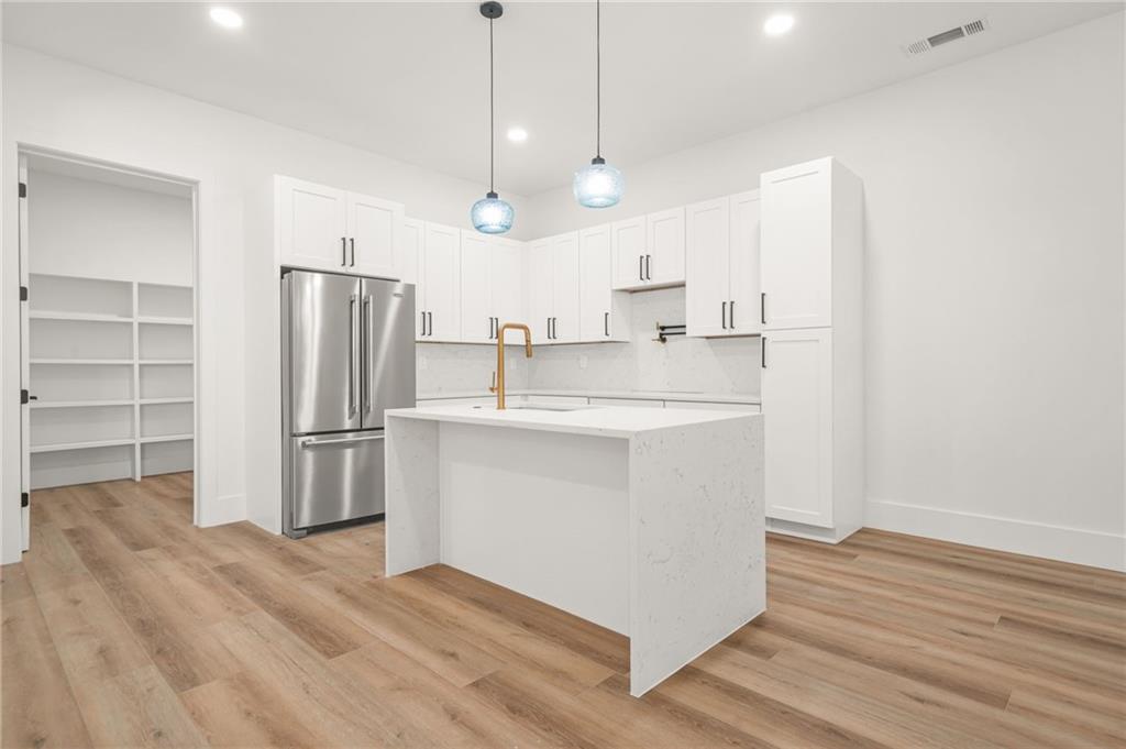 5175 Cascade Road Atlanta, GA 30331 - Photo 36 of 62 a kitchen with kitchen island a sink stainless steel appliances and cabinets