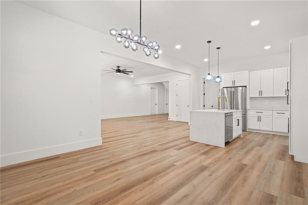 5175 Cascade Road Atlanta, GA 30331 - Photo 37 of 62 a view of a kitchen with kitchen island a sink wooden floor and a refrigerator