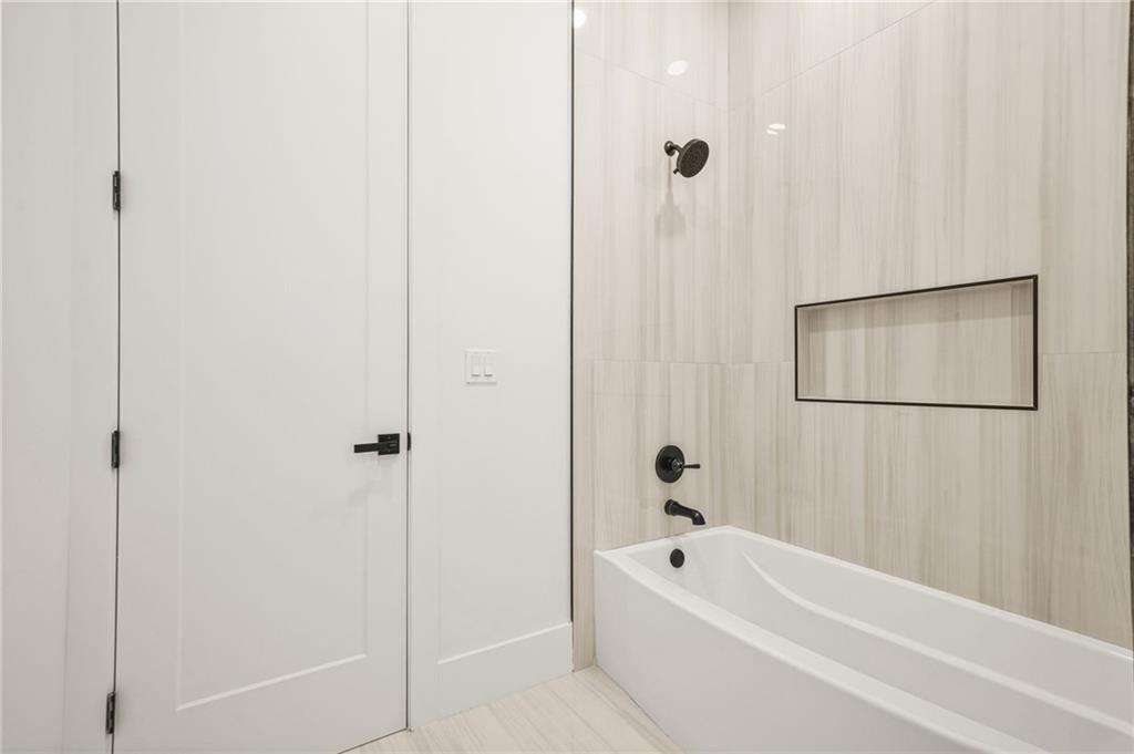 5175 Cascade Road Atlanta, GA 30331 - Photo 43 of 62 a bathroom with a tub shower and a sink