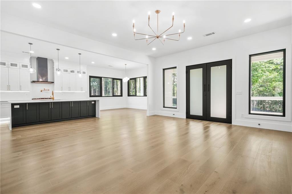 5175 Cascade Road Atlanta, GA 30331 - Photo 5 of 62 an empty room with wooden floor and windows