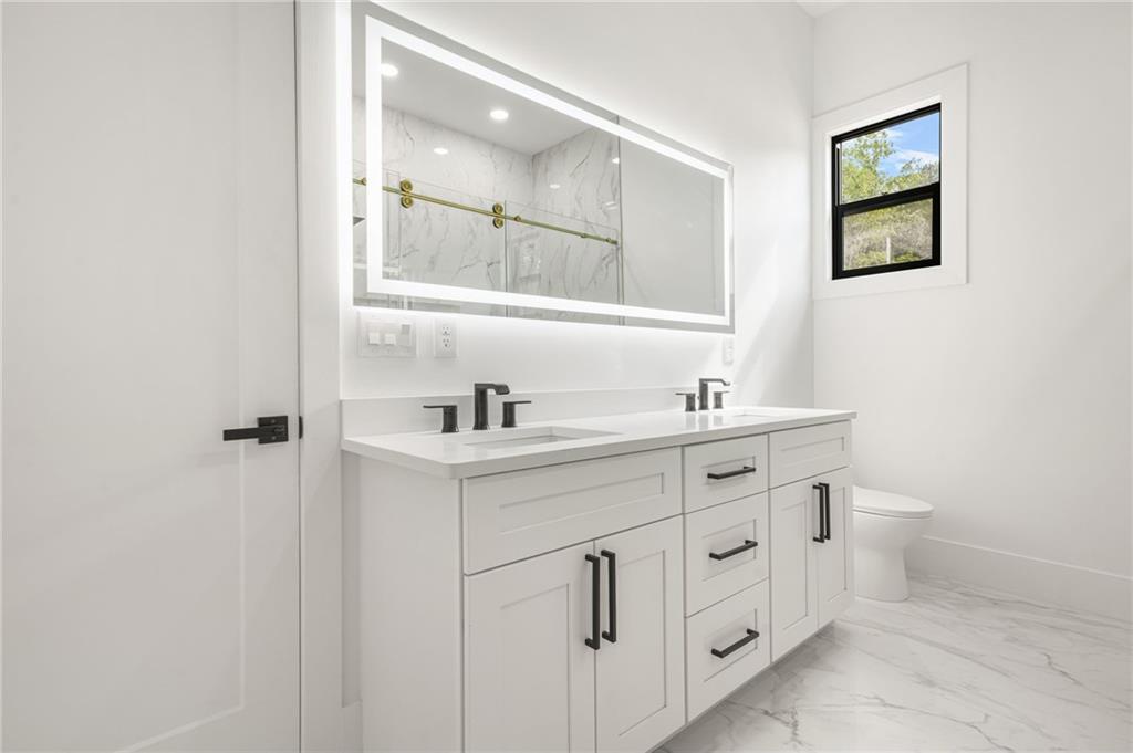 5175 Cascade Road Atlanta, GA 30331 - Photo 53 of 62 a spacious bathroom with a double vanity sink a mirror and a