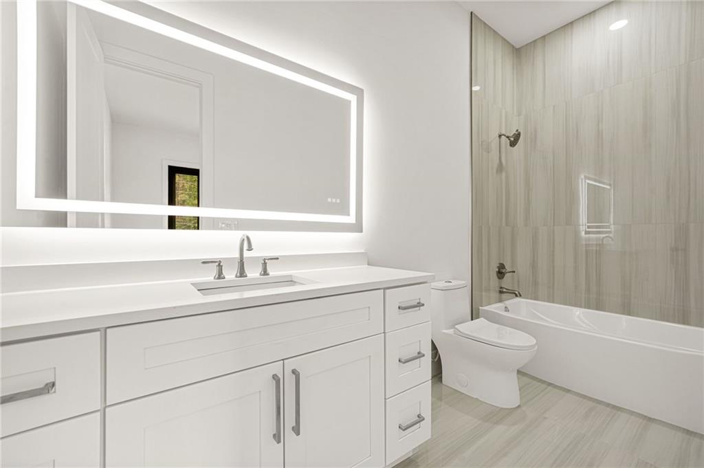 5175 Cascade Road Atlanta, GA 30331 - Photo 57 of 62 a bathroom with a toilet a sink a tub and mirror