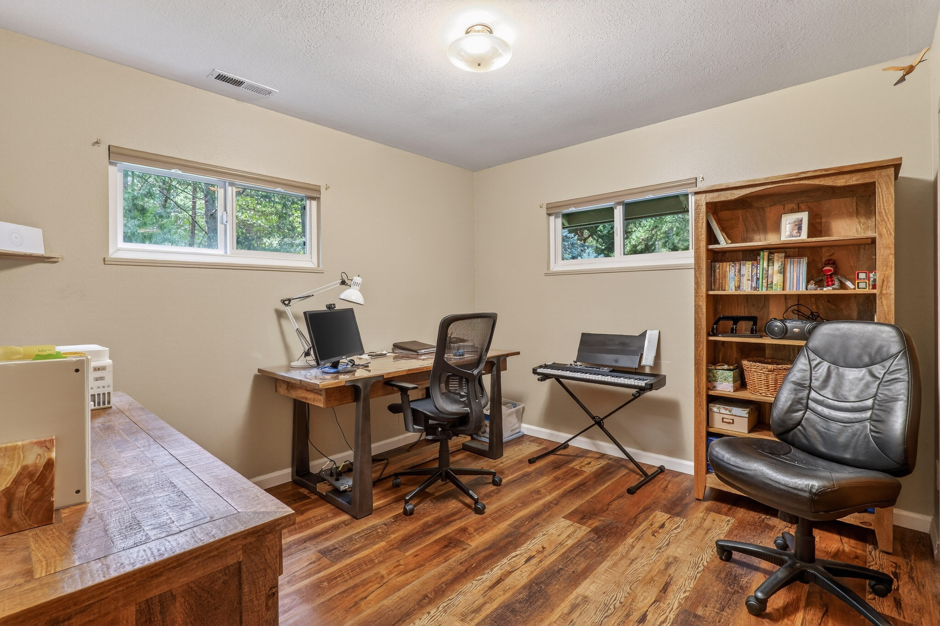 244 Riessen Road Grants Pass, OR 97526 - Photo 30 of 52 a work room with furniture and a wooden floor
