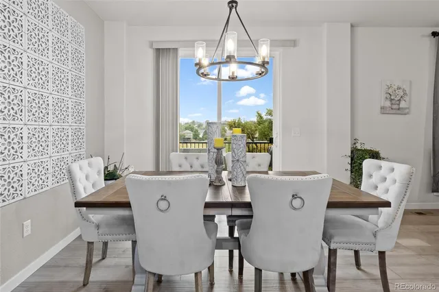 a view of a dining room with furniture wooden floor and chandelier