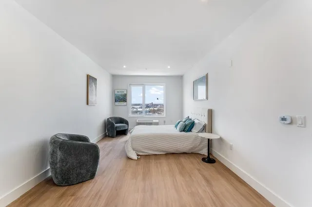 a bedroom with furniture and a wooden floor
