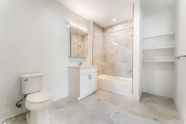 a bathroom with a toilet a sink and bathtub