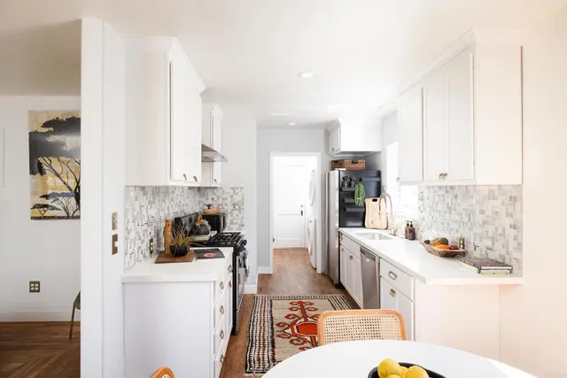 a kitchen with stainless steel appliances a refrigerator a sink a stove a microwave and cabinets