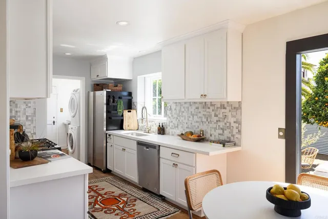 a kitchen with a sink cabinets and appliances